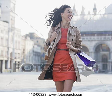 Smiling woman with shopping bags walking in St. Mark's Square in Venic View Large Photo Image Stock Image - Smiling woman with shopping bags walking in St. Mark's Square in Venic. Fotosearch