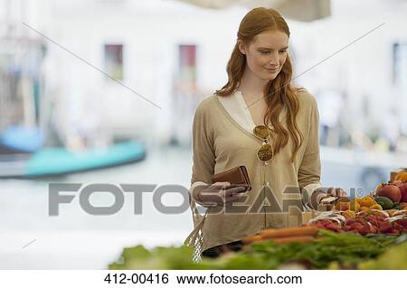 Woman shopping in outdoor market View Large Photo Image Stock Photograph - Woman shopping in outdoor market. Fotosearch