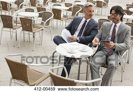 Businessmen meeting at sidewalk cafe View Large Photo Image Stock Photo - Businessmen meeting at sidewalk cafe. Fotosearch