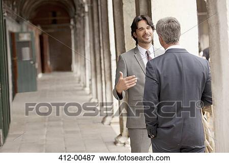 Businessmen talking in corridor View Large Photo Image Stock Photo - Businessmen talking in corridor. Fotosearch