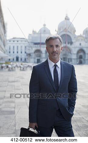 Stock Image - Portrait of confident businessman in St. Mark's Square in Venice. Fotosearch
