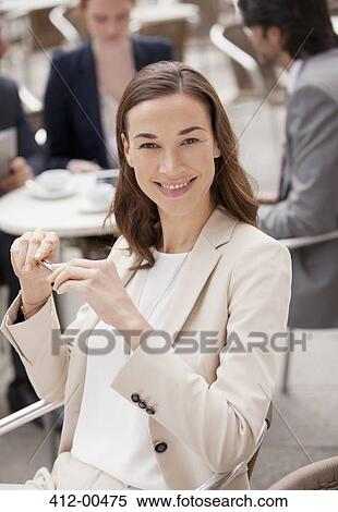 Portrait of smiling businesswoman at sidewalk cafe View Large Photo Image Stock Photography - Portrait of smiling businesswoman at sidewalk cafe. Fotosearch
