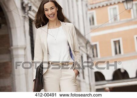Portrait of smiling businesswoman walking View Large Photo Image Stock Image - Portrait of smiling businesswoman walking. Fotosearch