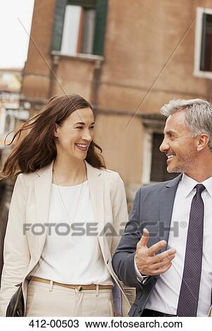 Smiling business people talking View Large Photo Image Stock Image - Smiling business people talking. Fotosearch