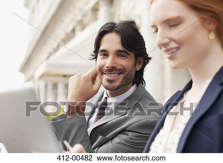 Smiling businessman and businesswoman using digital tablet View Large Photo Image Stock Image - Smiling businessman and businesswoman using digital tablet. Fotosearch