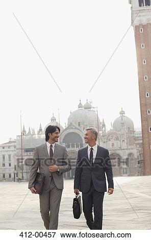 Smiling businessmen walking through St. Mark's Square in Venic View Large Photo Image Stock Photo - Smiling businessmen walking through St. Mark's Square in Venic. Fotosearch