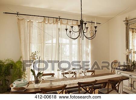 Chandelier over dining room table View Large Photo Image Stock Photo - Chandelier over dining room table. Fotosearch