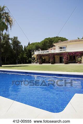 Luxury lap pool and Spanish villa View Large Photo Image Stock Photography - Luxury lap pool and Spanish villa. Fotosearch