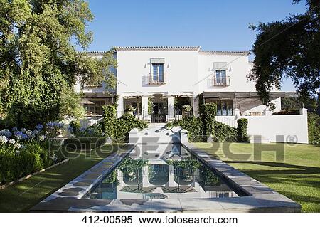 Stock Photography - Luxury lap pool and Spanish villa. Fotosearch