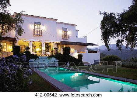 Luxury lap pool and villa at dusk View Large Photo Image Stock Image - Luxury lap pool and villa at dusk. Fotosearch