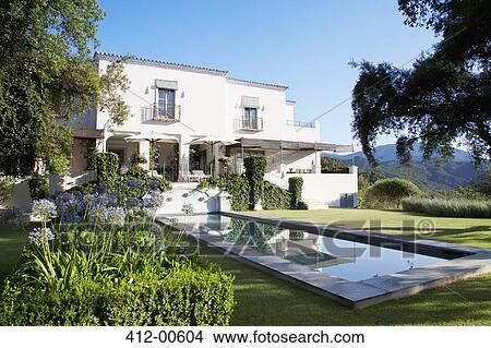 Luxury lap pool and villa View Large Photo Image Picture - Luxury lap pool and villa. Fotosearch
