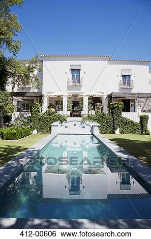 Luxury lap pool and villa View Large Photo Image Stock Photograph - Luxury lap pool and villa. Fotosearch