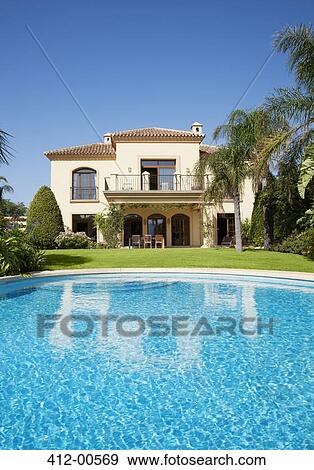 Luxury swimming pool and Spanish villa View Large Photo Image Stock Photo - Luxury swimming pool and Spanish villa. Fotosearch