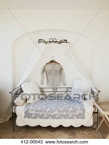 Shirt hanging over day bed with canopy on patio View Large Photo Image Stock Image - Shirt hanging over day bed with canopy on patio. Fotosearch