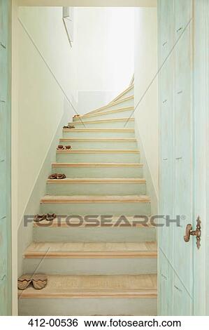 Slippers lining stairs View Large Photo Image Stock Photograph - Slippers lining stairs. Fotosearch