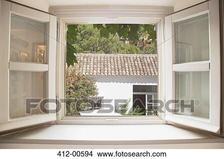 Picture - Sun shining through kitchen window. Fotosearch