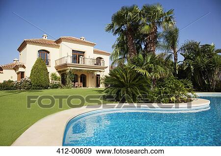 Swimming pool and Spanish villa View Large Photo Image Stock Photo - Swimming pool and Spanish villa. Fotosearch