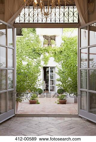 View of courtyard through French doors View Large Photo Image Stock Photo - View of courtyard through French doors. Fotosearch