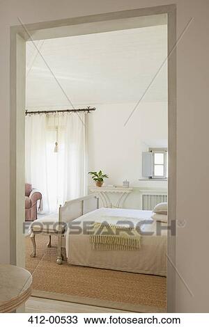 Stock Image - View of luxury bedroom through doorway. Fotosearch