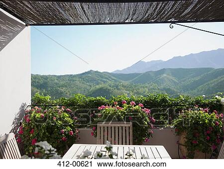 View of mountains from balcony with potted flowers View Large Photo Image Stock Image - View of mountains from balcony with potted flowers. Fotosearch