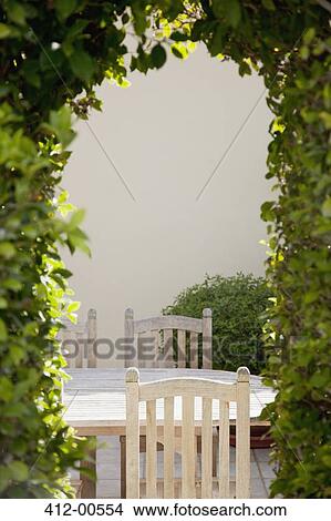 View of patio table through vine-covered pergola View Large Photo Image Picture - View of patio table through vine-covered pergola. Fotosearch