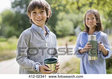 Children drinking from thermos outdoors View Large Photo Image Stock Image - Children drinking from thermos outdoors. Fotosearch