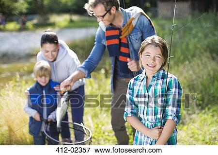 Family admiring fishing catch outdoors View Large Photo Image Stock Photo - Family admiring fishing catch outdoors. Fotosearch