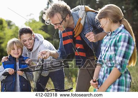 Stock Photo - Family admiring fishing catch. Fotosearch