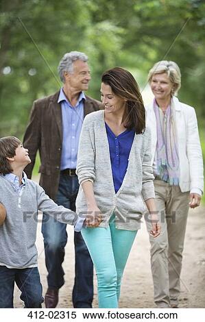 Stock Photography - Family walking on rural road. Fotosearch