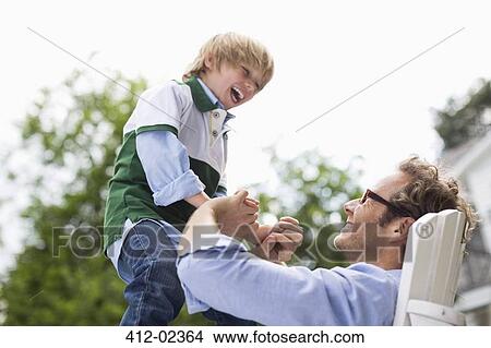 Picture - Father and son playing outdoors. Fotosearch