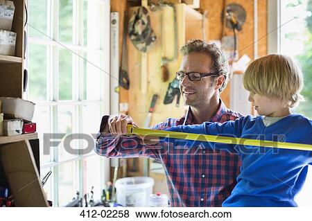 Father and son working in garage View Large Photo Image Stock Photo - Father and son working in garage. Fotosearch