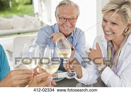 Friends toasting each other with wine View Large Photo Image Picture - Friends toasting each other with wine. Fotosearch