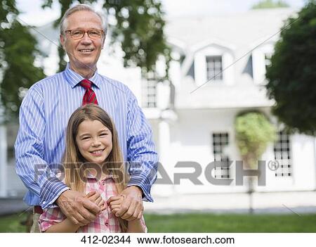 Man and granddaughter smiling outdoors View Large Photo Image Picture - Man and granddaughter smiling outdoors. Fotosearch