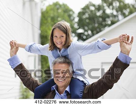 Man carrying granddaughter on shoulders View Large Photo Image Stock Photograph - Man carrying granddaughter on shoulders. Fotosearch