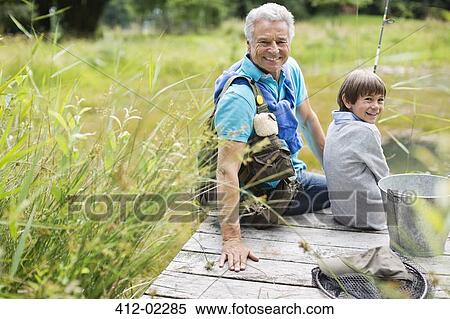 Man fishing with grandson on wooden dock View Large Photo Image Stock Photography - Man fishing with grandson on wooden dock. Fotosearch