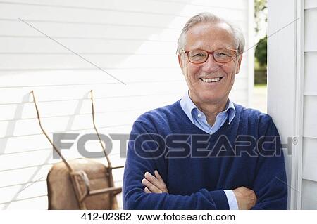Man smiling outside house View Large Photo Image Stock Image - Man smiling outside house. Fotosearch