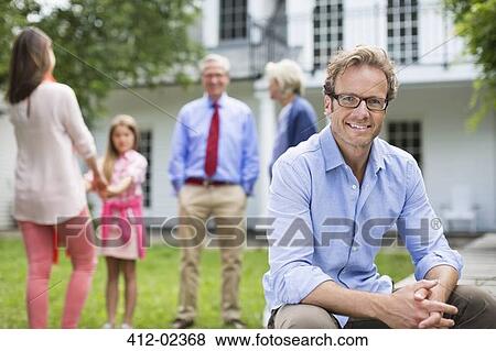 Man smiling outside house View Large Photo Image Stock Photo - Man smiling outside house. Fotosearch