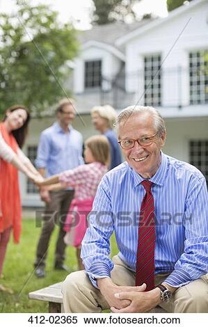 Man smiling outside house View Large Photo Image Stock Photography - Man smiling outside house. Fotosearch