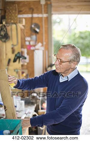 Man working in garage View Large Photo Image Stock Image - Man working in garage. Fotosearch