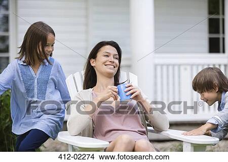 Mother and children relaxing outdoors View Large Photo Image Picture - Mother and children relaxing outdoors. Fotosearch