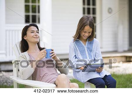 Stock Photo - Mother and daughter relaxing outdoors. Fotosearch