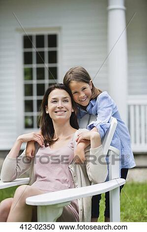 Stock Image - Mother and daughter smiling together outdoors. Fotosearch