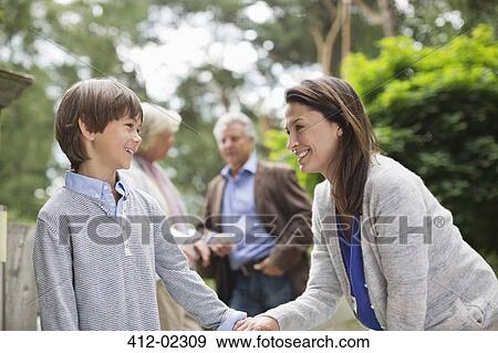 Mother walking with son outdoors View Large Photo Image Stock Photo - Mother walking with son outdoors. Fotosearch