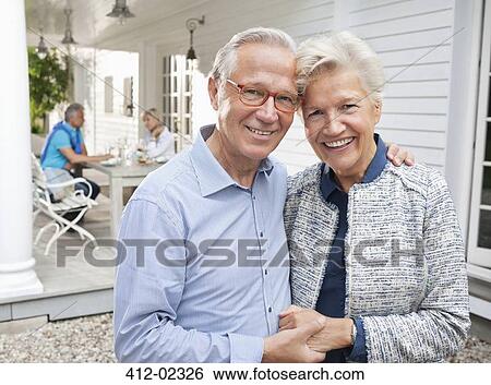 Smiling couple hugging outdoors View Large Photo Image Stock Photograph - Smiling couple hugging outdoors. Fotosearch