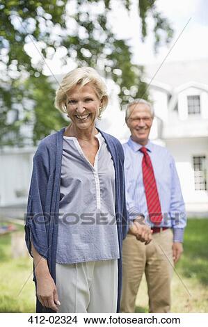 Picture - Smiling couple walking outdoors. Fotosearch