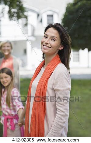 Stock Photography - Three generations of women smiling outdoors. Fotosearch