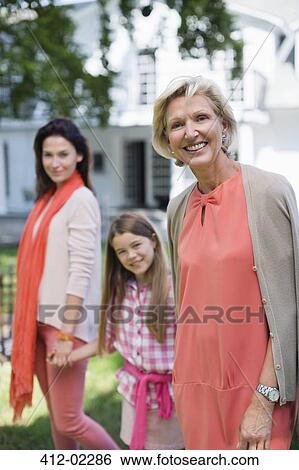 Stock Photograph - Three generations of women walking together. Fotosearch
