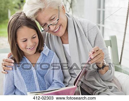 Woman and granddaughter reading on porch swing View Large Photo Image Stock Image - Woman and granddaughter reading on porch swing. Fotosearch