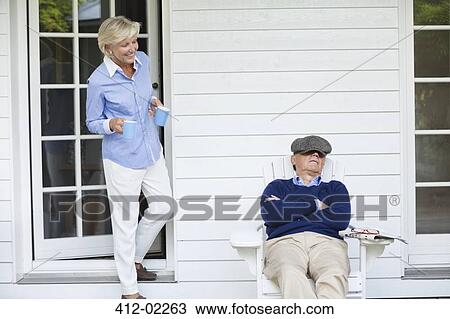 Woman bringing coffee to sleeping husband View Large Photo Image Stock Image - Woman bringing coffee to sleeping husband. Fotosearch