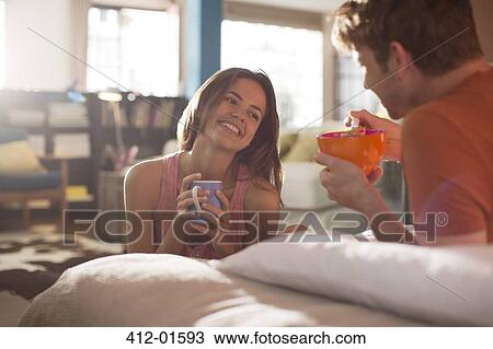Couple having breakfast in bed together View Large Photo Image Stock Image - Couple having breakfast in bed together. Fotosearch